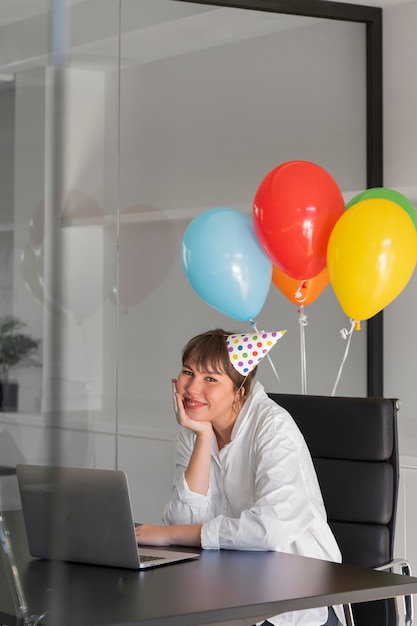 Medium shot smiley woman wearing party hat