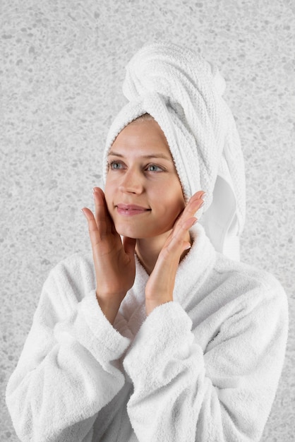 Medium shot smiley woman wearing towel