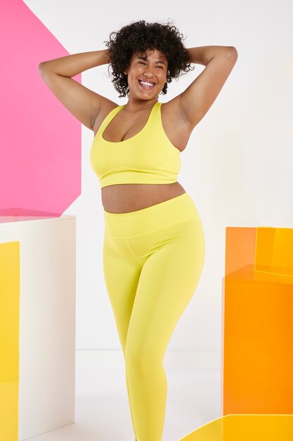 Medium shot smiley woman wearing yellow outfit
