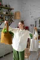 Free photo medium shot smiley woman with bags