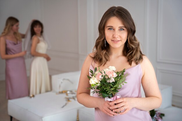 Medium shot smiley woman with bouquet