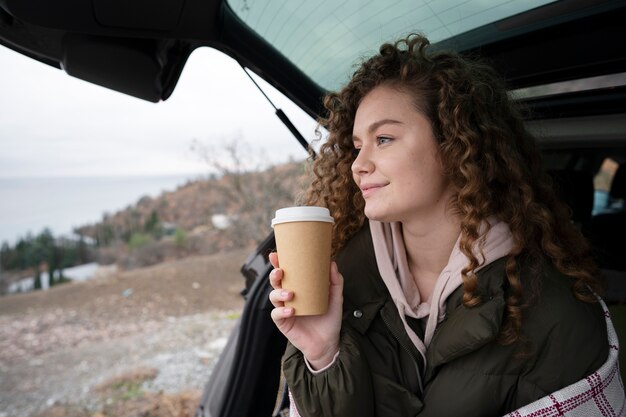 Medium shot smiley woman with coffee cup