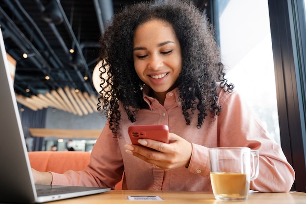 Medium shot smiley woman with devices