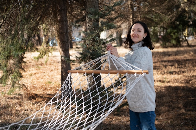 Free photo medium shot smiley woman with hammock