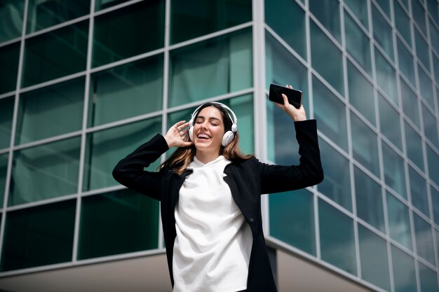 Medium shot smiley woman with headphones