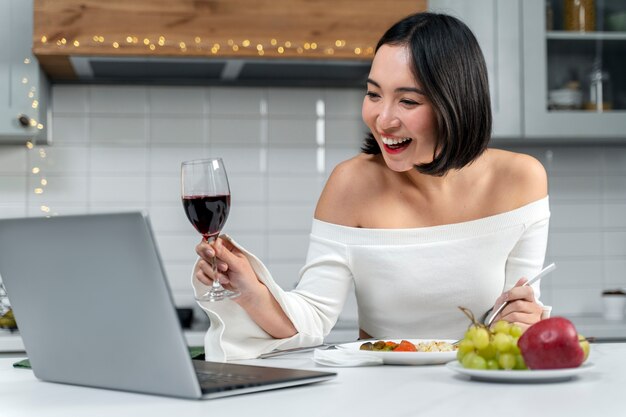 Medium shot smiley woman with laptop