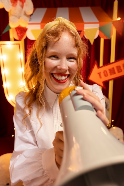 Free photo medium shot smiley woman with megaphone