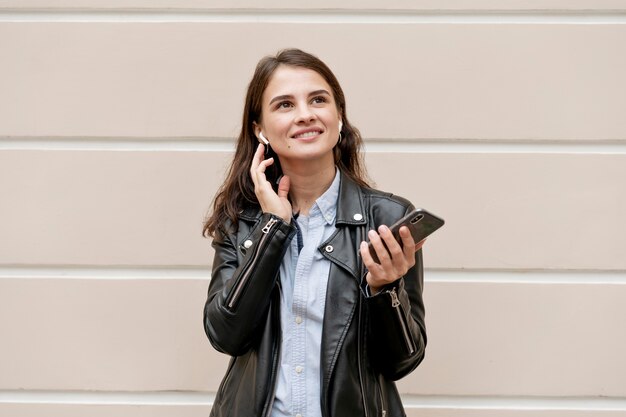 Medium shot smiley woman with phone