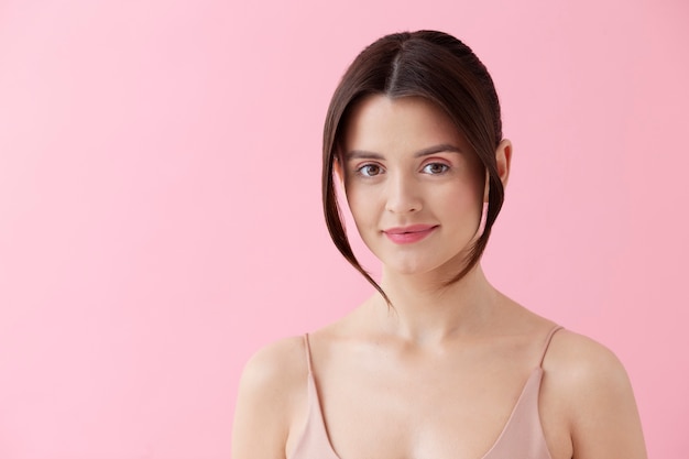 Medium shot smiley woman with pink background