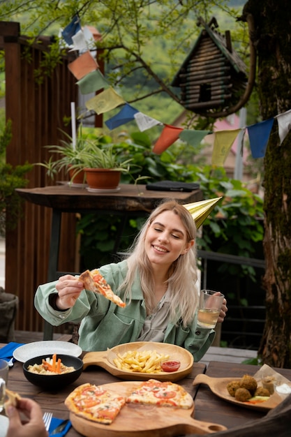 Medium shot smiley woman with pizza