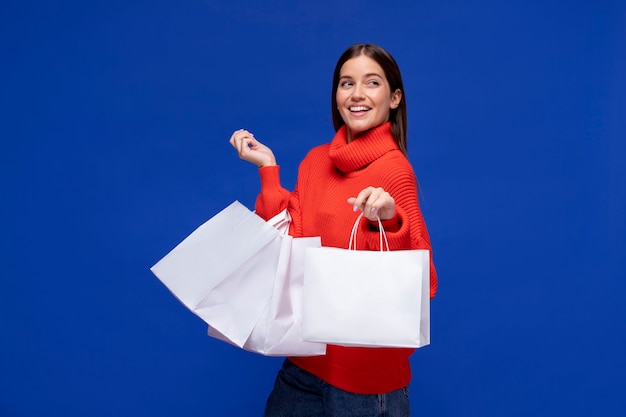 Medium shot smiley woman with shopping bags