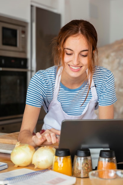 Medium shot smiley woman with tablet