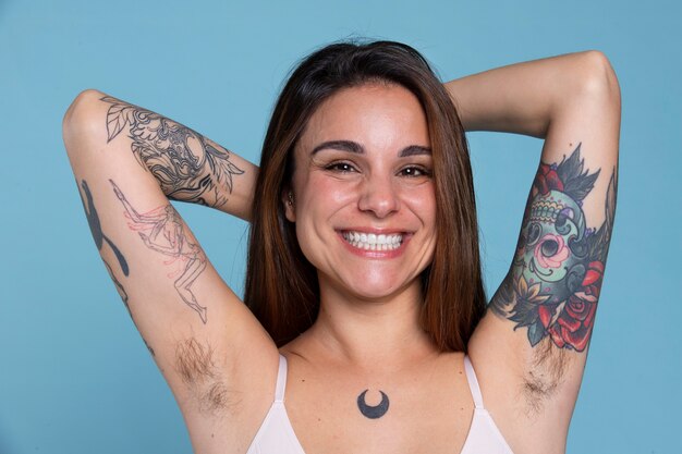 Medium shot smiley woman with tattoos