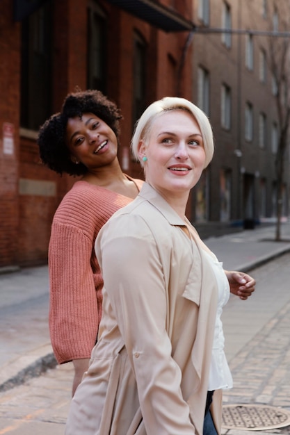 Medium shot smiley women in city