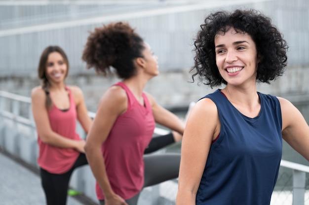 Free photo medium shot smiley women doing sport