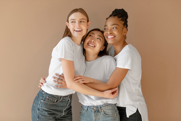 Medium shot smiley women holding each other