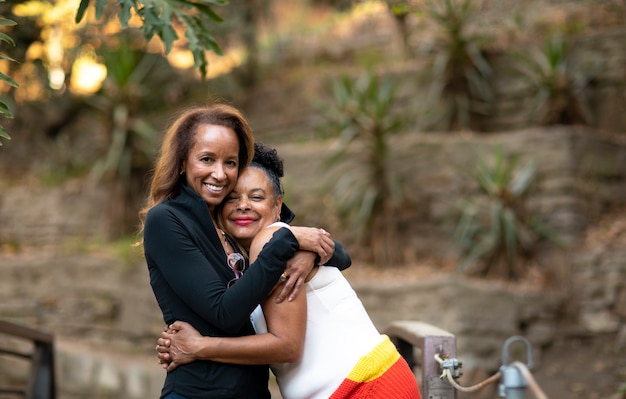 Medium shot smiley women hugging