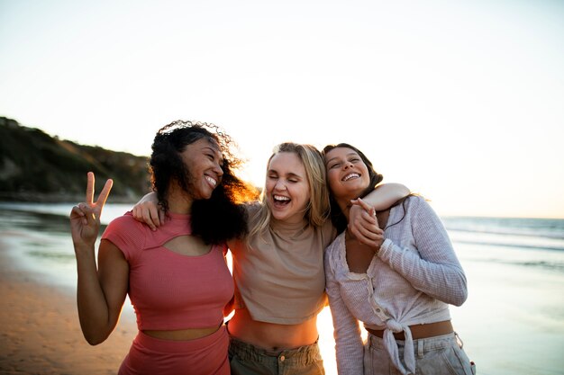 Medium shot smiley women at seaside