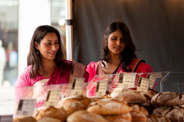 Medium shot smiley women shopping for food