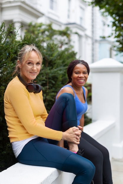 Free photo medium shot smiley women sitting together