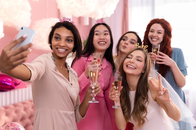 Medium shot smiley women taking selfie