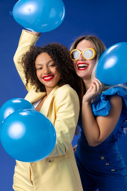 Medium shot smiley women with balloons