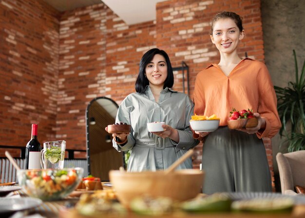 Medium shot smiley women with food