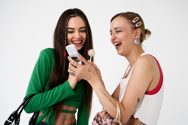 Medium shot smiley women with phone