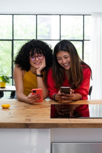 Medium shot smiley women with phones