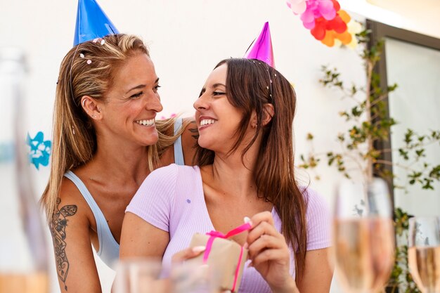 Medium shot smiley women with present