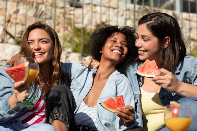 Medium shot smiley women with watermelon