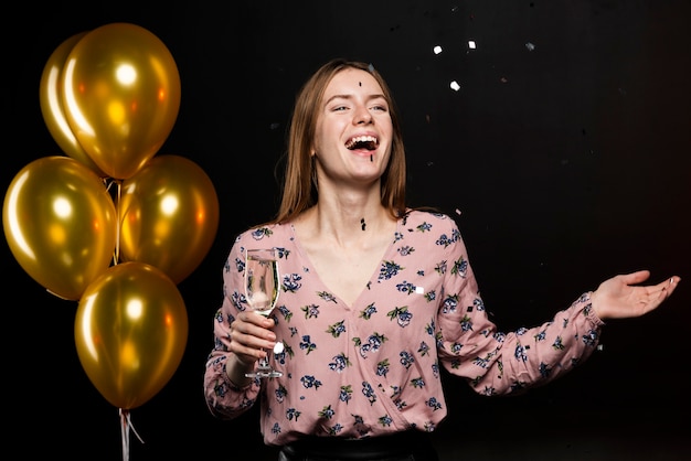 Medium shot of smiling woman at new years party