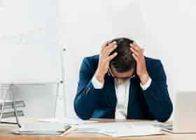 Free photo medium shot stressed man looking at papers