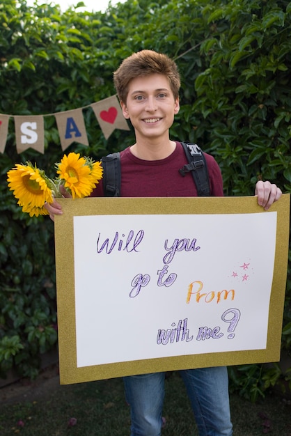 Free photo medium shot student holding banner