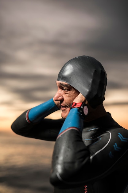 Medium shot swimmer putting on cap