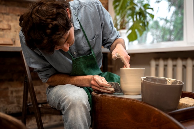 Medium shot talented man doing pottery