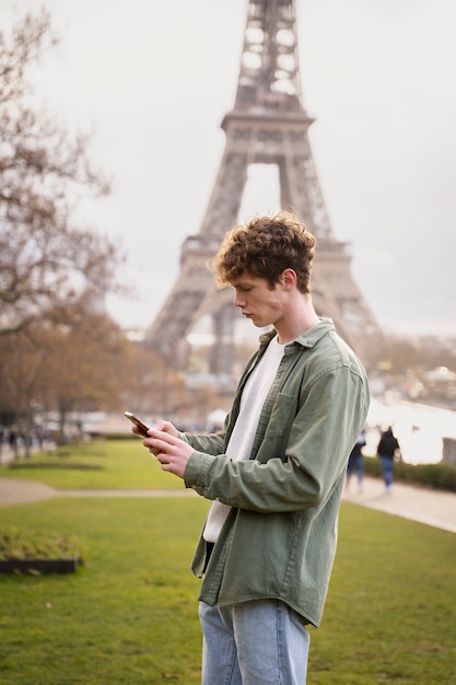 Medium shot teen holding smartphone