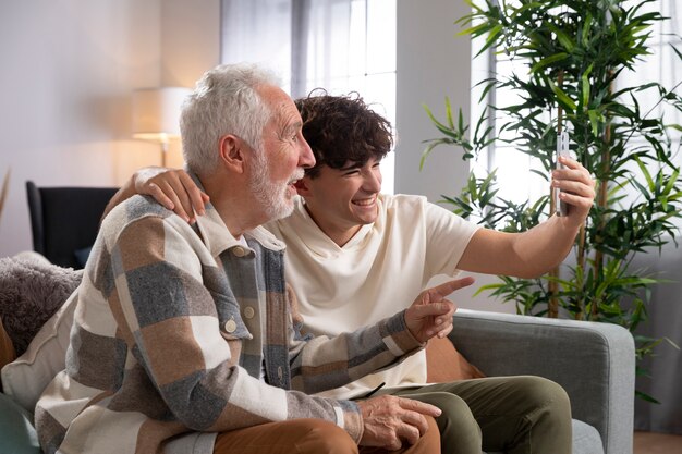 Medium shot teen and man taking selfie