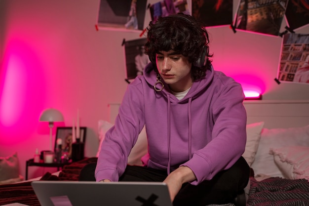 Medium shot teen with laptop at home