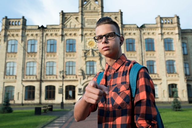 Medium shot teenage boy pointing at camera