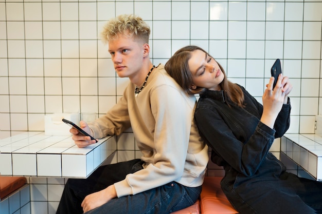 Medium shot teenagers with smartphones