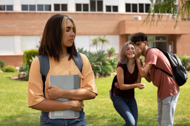Medium shot teens bullying girl at school