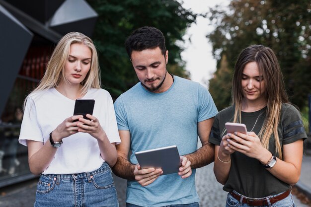 Medium-shot  teens checking their phones