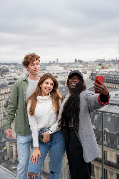 Medium shot teens taking selfie
