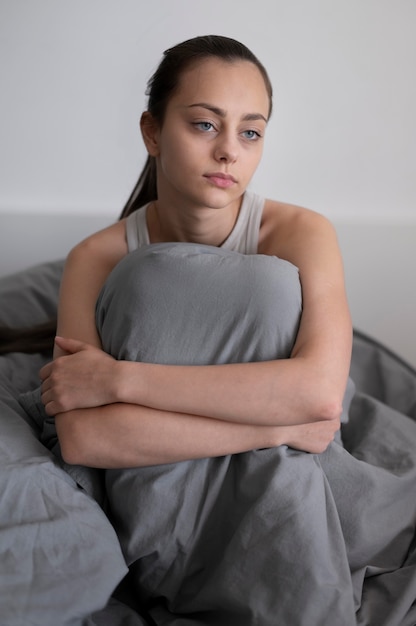 Medium shot tired woman in bed