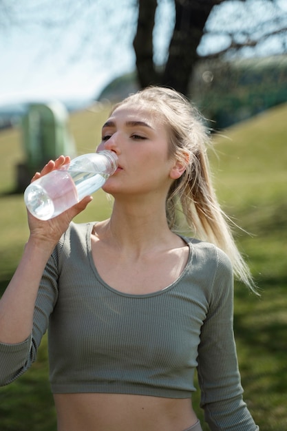 Medium shot tired woman drinking water