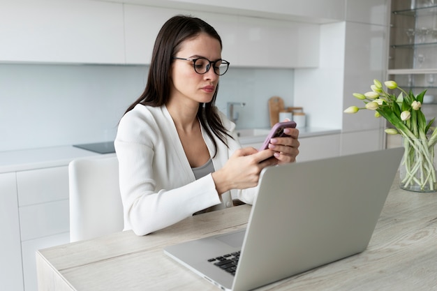 Medium shot tired woman working at home