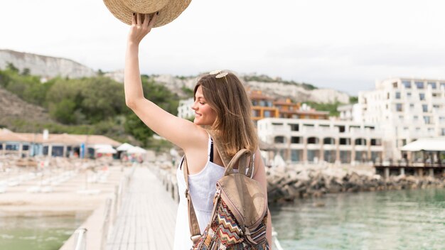 Medium shot tourist posing with hat