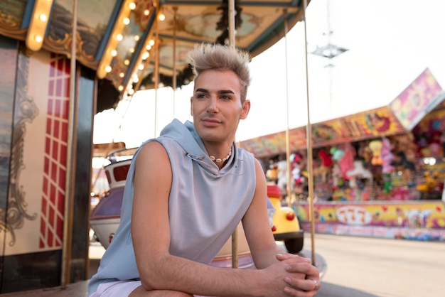 Free photo medium shot transgender sitting outdoors