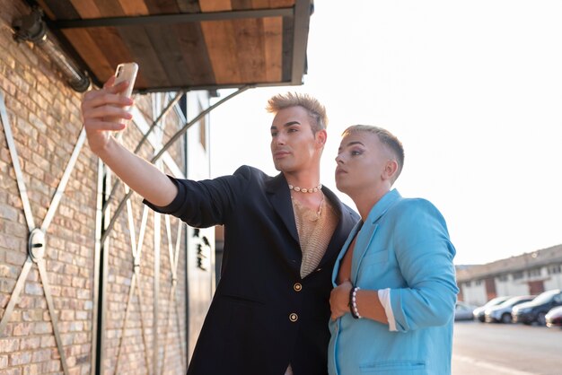 Medium shot transgenders taking selfie